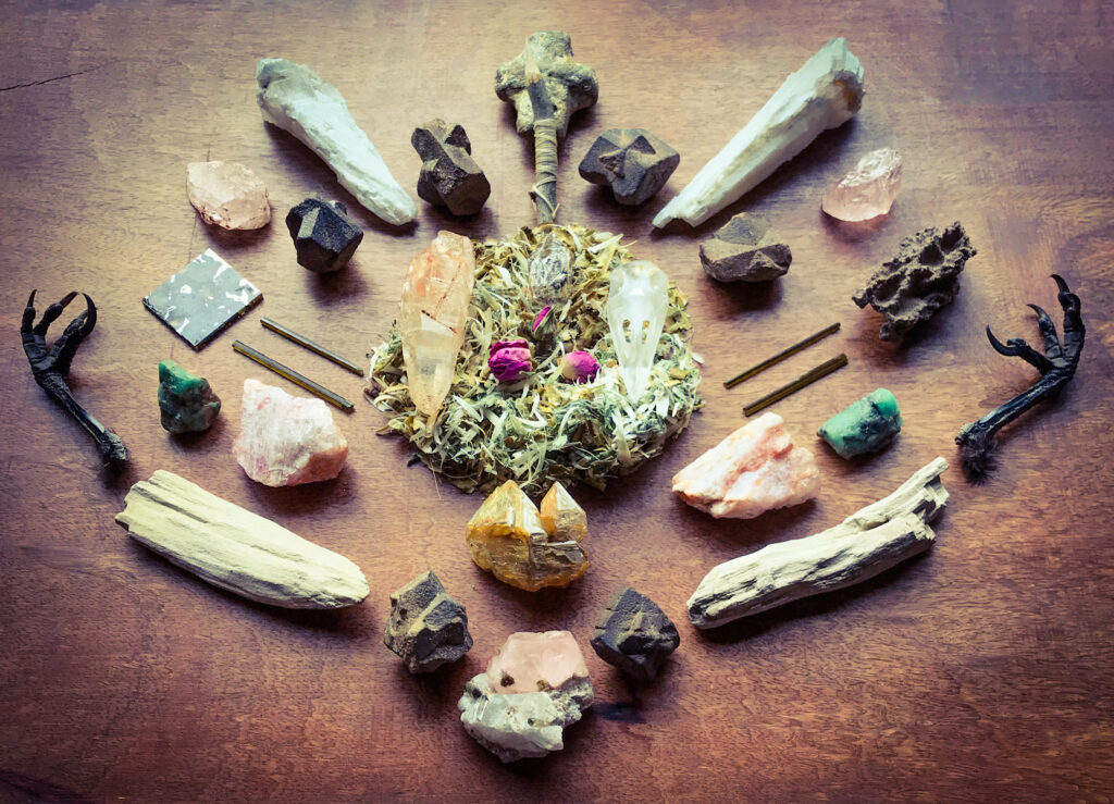 Shavings of the Willow of my Drum Sounder with dried Roses, A Hawthorn sprig with seven golden Horse hairs, Staurolite, White Druide Quartz, Quartz, Morganite, Dravite, Seycham Pallasite, Emerald, Celestial Fenster Quartz, Petrified Wood and Crow claws
